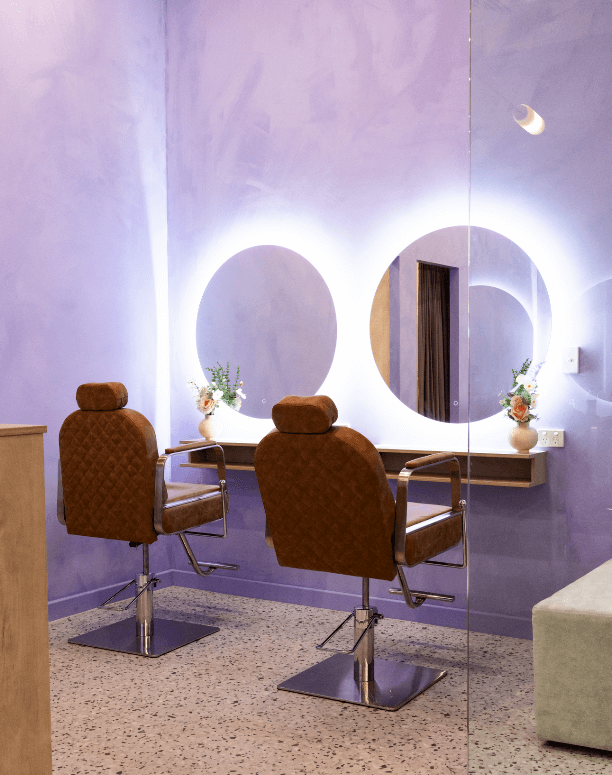 Purple and white colour palette, LED backlit circular mirrors and render french wall paper for this commercial wellness and beauty fit out for Elegant Brows